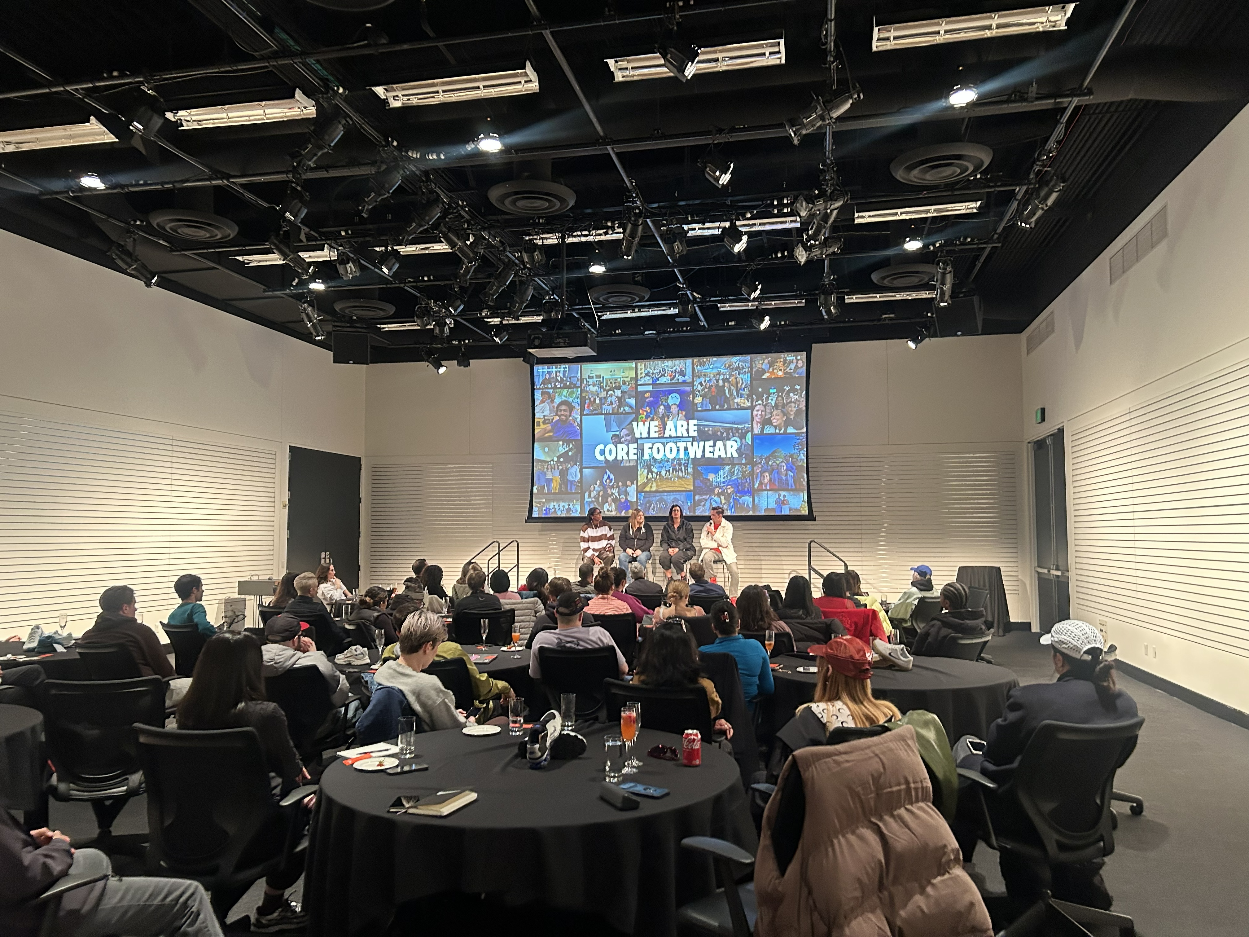 Michelle Snow speaking on the Core Footwear panel to an audience seated at round tables